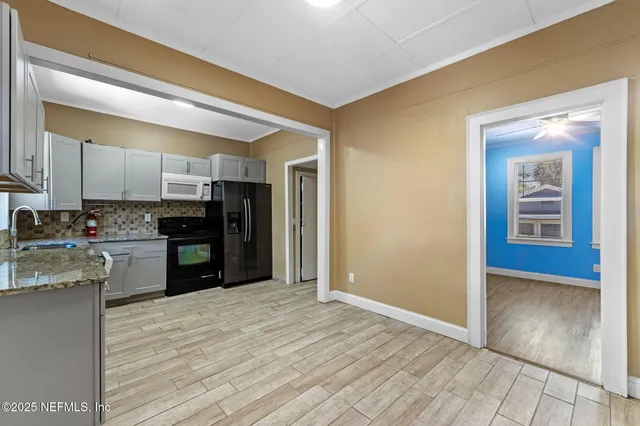 a kitchen with stainless steel appliances granite countertop a refrigerator and a sink