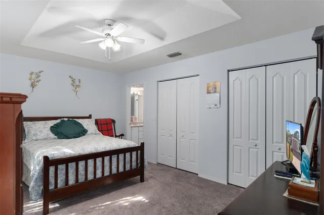 a bedroom with furniture and a chandelier
