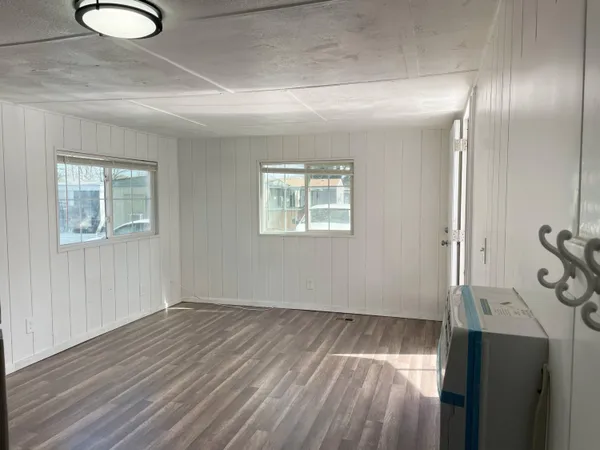 a view of a room with wooden floor and window