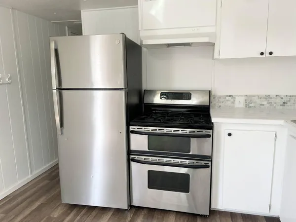 a kitchen with cabinets and stainless steel appliances