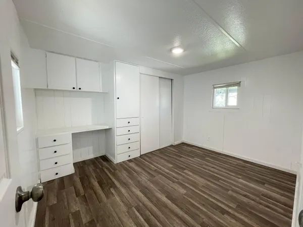 a room with a dresser and a window