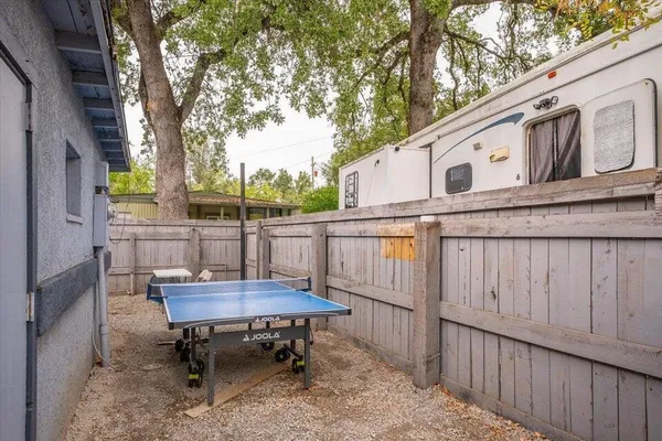 a backyard of a house with table and chairs