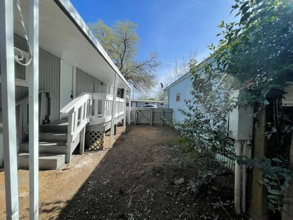 a view of an house with backyard and trees