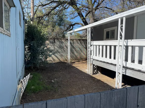 a view of a house with a yard with wooden fence