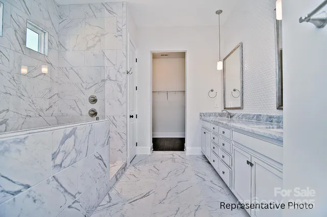 a view of an empty room with a fireplace and windows