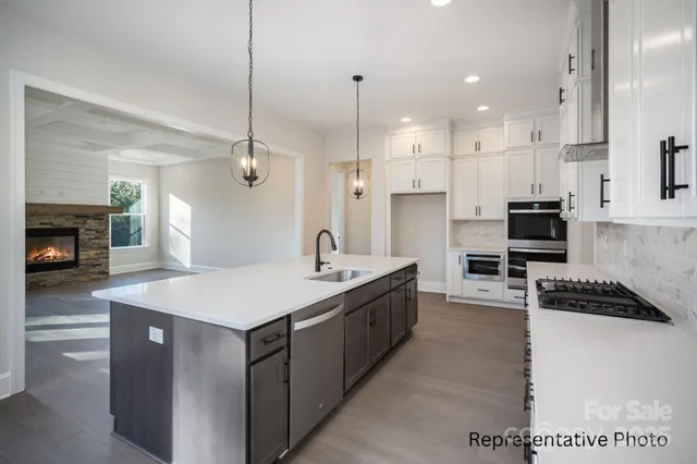 a kitchen with a sink stove and refrigerator