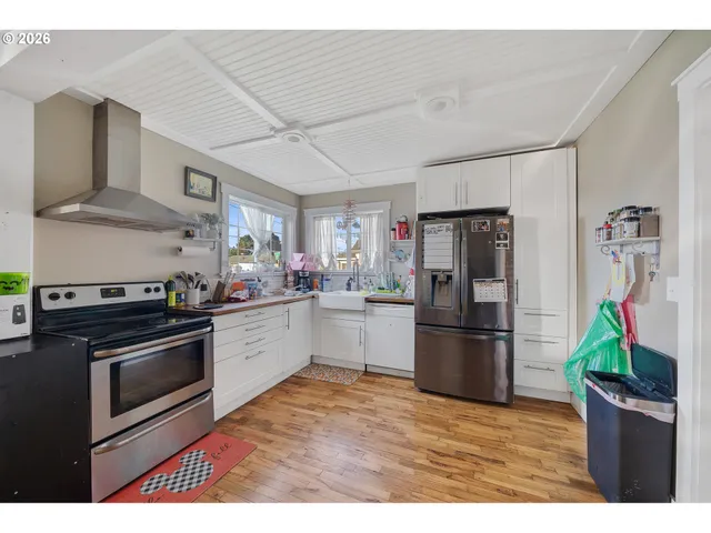 a kitchen with a stove a refrigerator and a sink