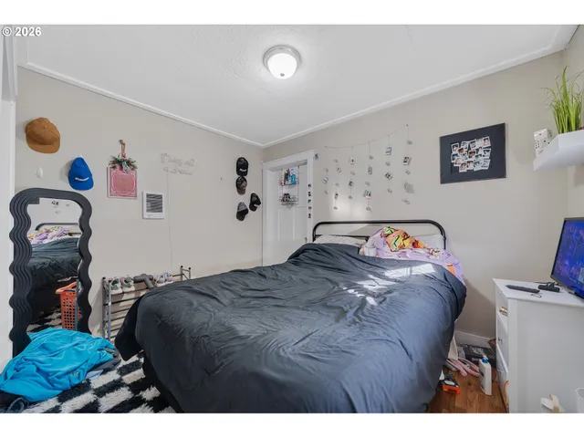 a bedroom with a bed and a television