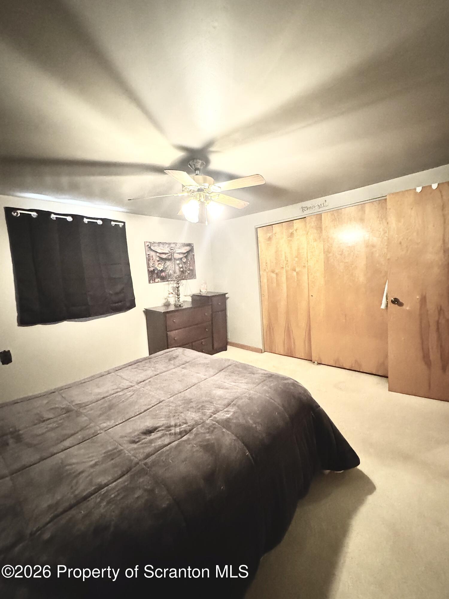 420 Delaware Street Jermyn, PA 18433 - Photo 11 of 22 a bedroom with a bed and a large mirror