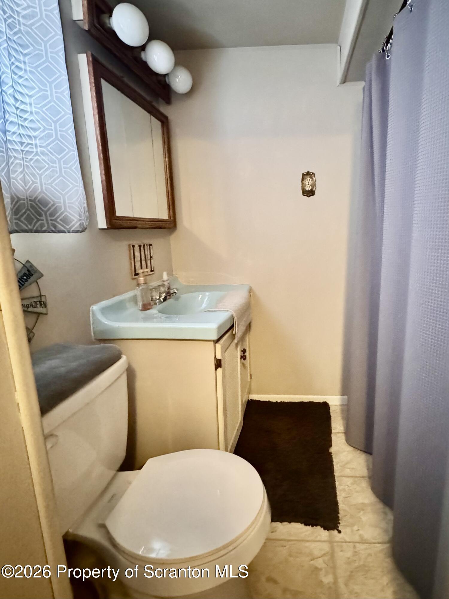 420 Delaware Street Jermyn, PA 18433 - Photo 14 of 22 a bathroom with a toilet sink and mirror