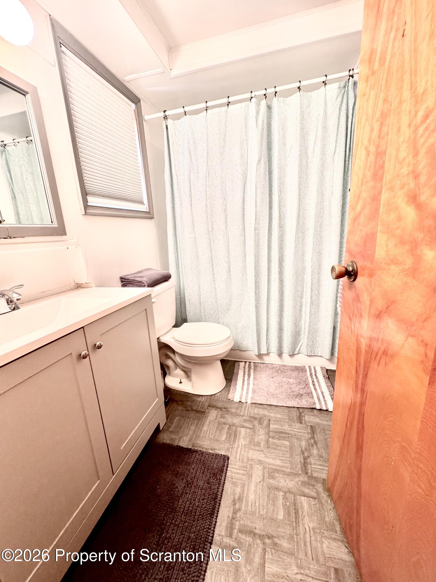420 Delaware Street Jermyn, PA 18433 - Photo 15 of 22 a bathroom with a sink a toilet a window and shower
