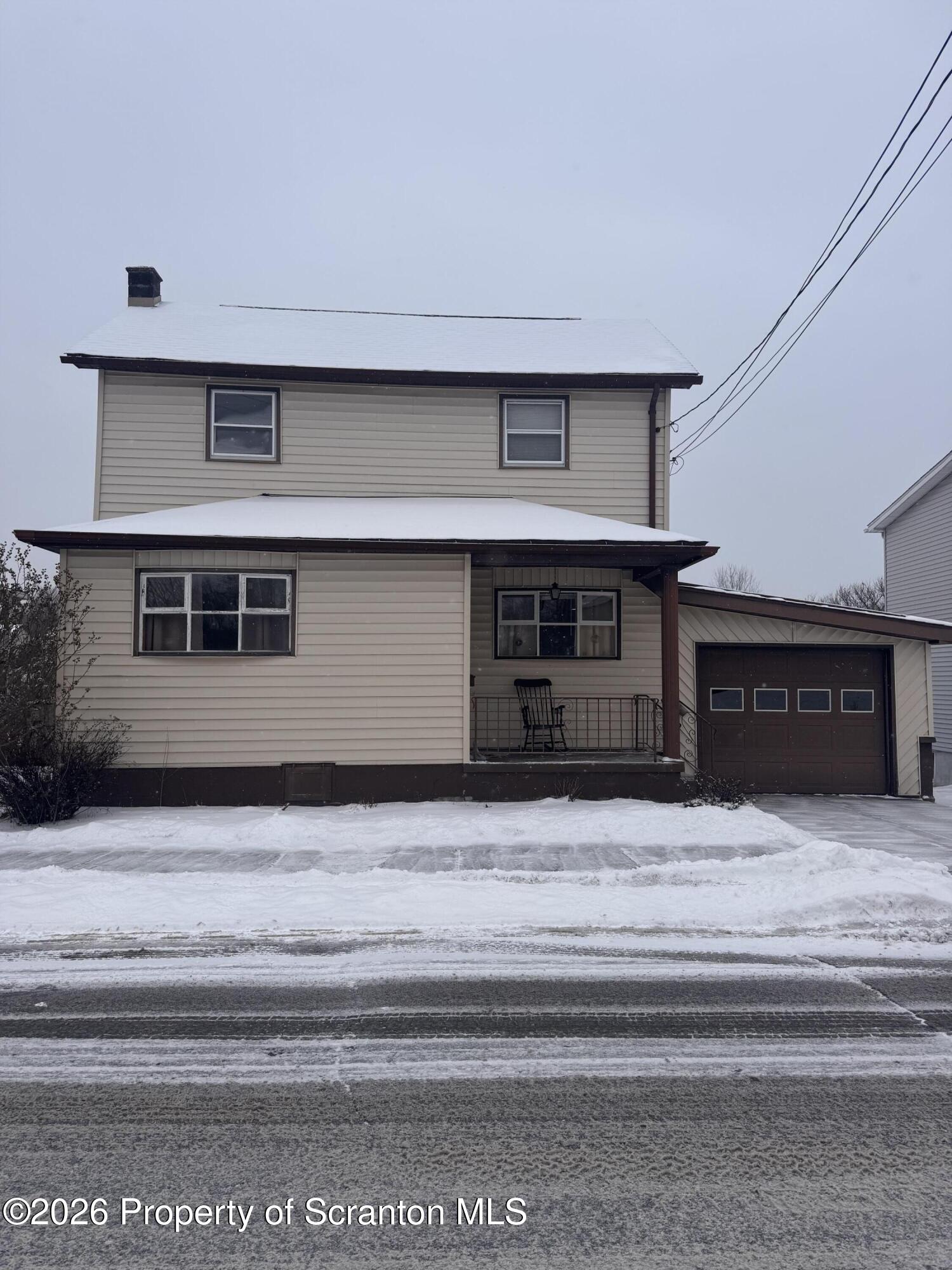 420 Delaware Street Jermyn, PA 18433 - Photo 2 of 22 a living room with a fireplace and a ceiling fan