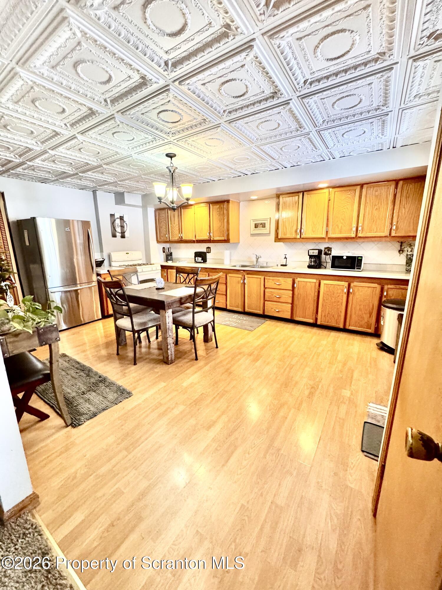420 Delaware Street Jermyn, PA 18433 - Photo 6 of 22 a living room with stainless steel appliances dining table and a large window