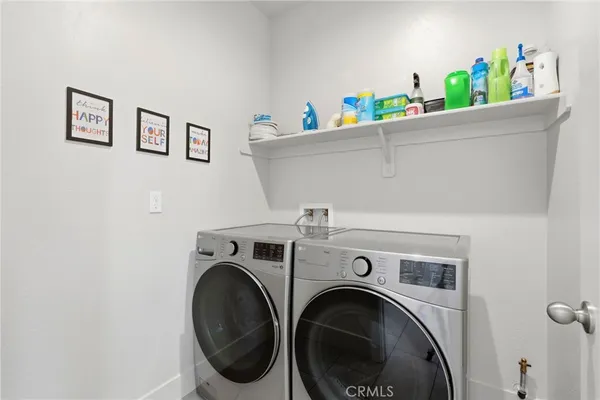 a living room with furniture and paintings on the wall