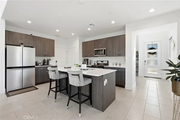 a kitchen with a sink dishwasher stove and cabinets