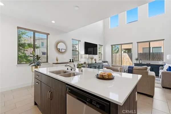a bathroom with a granite countertop double vanity sink a shower and a mirror