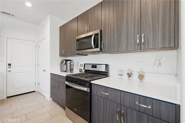 a bathroom with a granite countertop double vanity sinks a vanity a lamp and a mirror