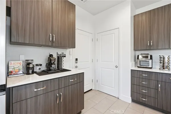 a bathroom with a granite countertop double vanity sink and a mirror