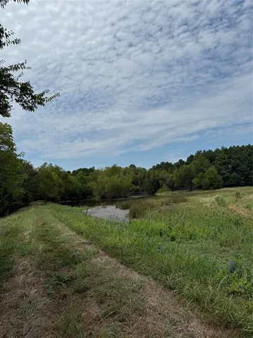 a view of a lake with houses in the back