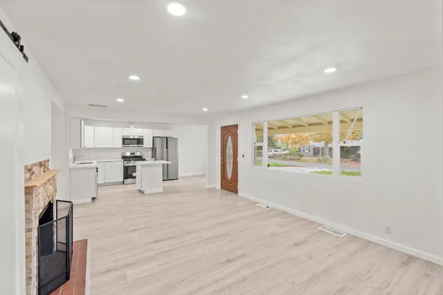 a view of kitchen with wooden floor and electronic appliances