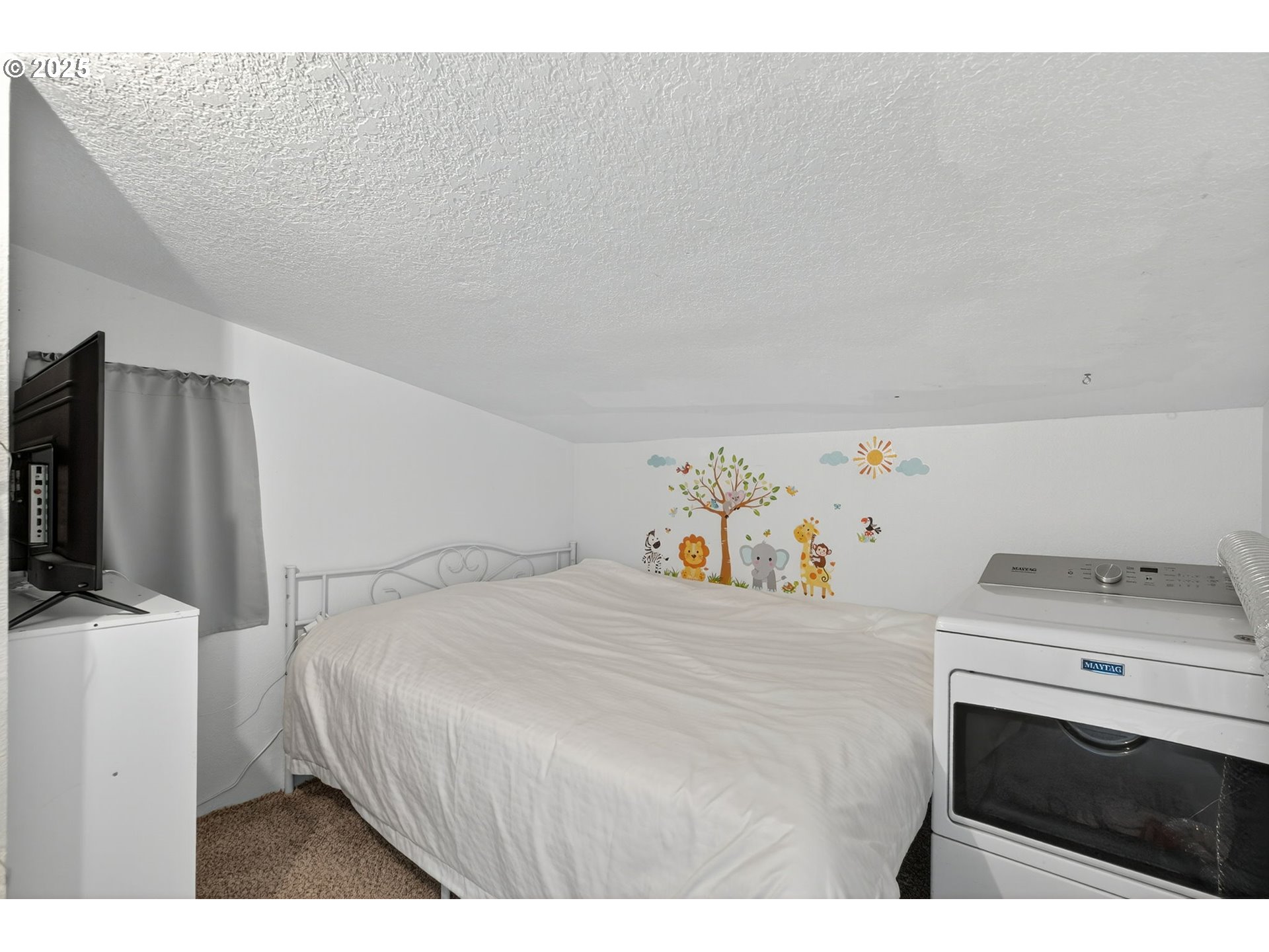 500 North Main Street Newberg, OR 97132 - Photo 18 of 23 a bedroom with a bed and a flat screen tv