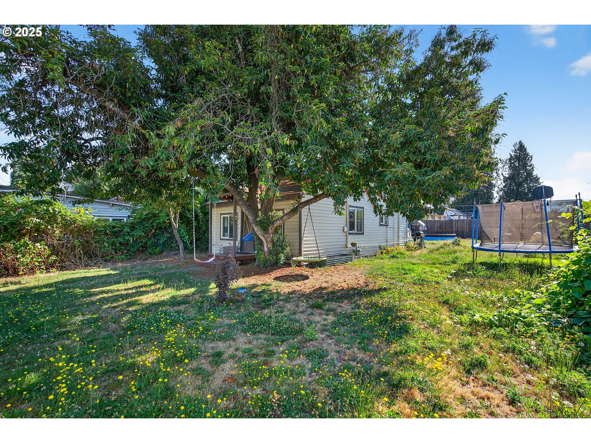 500 North Main Street Newberg, OR 97132 - Photo 21 of 23 a backyard of a house with yard and trampoline