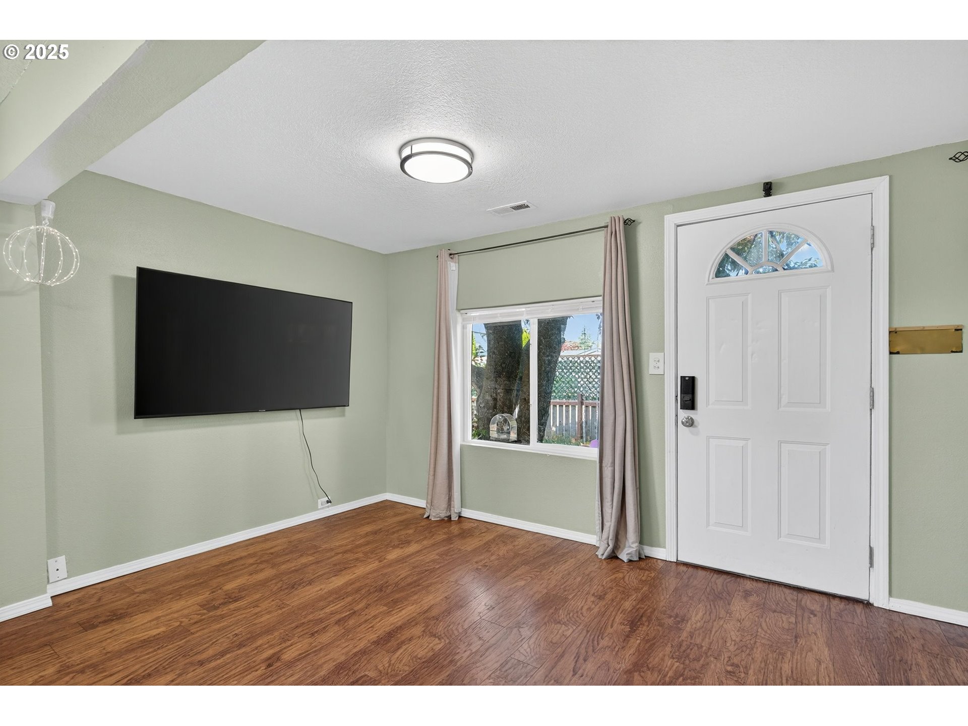 500 North Main Street Newberg, OR 97132 - Photo 3 of 23 a view of a livingroom with wooden floor and a flat screen tv