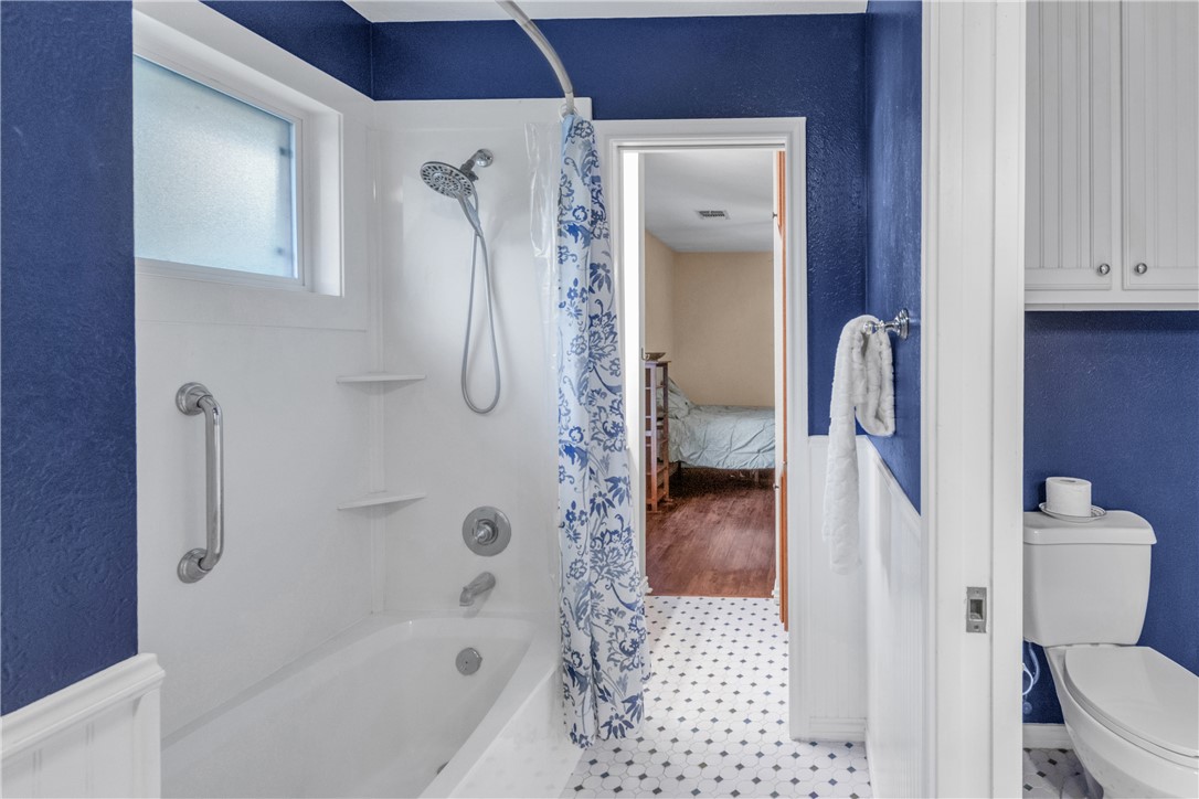 9997 Calhoun Road Bryan, TX 77808 - Photo 14 of 50 a bathroom with a shower a toilet and a sink