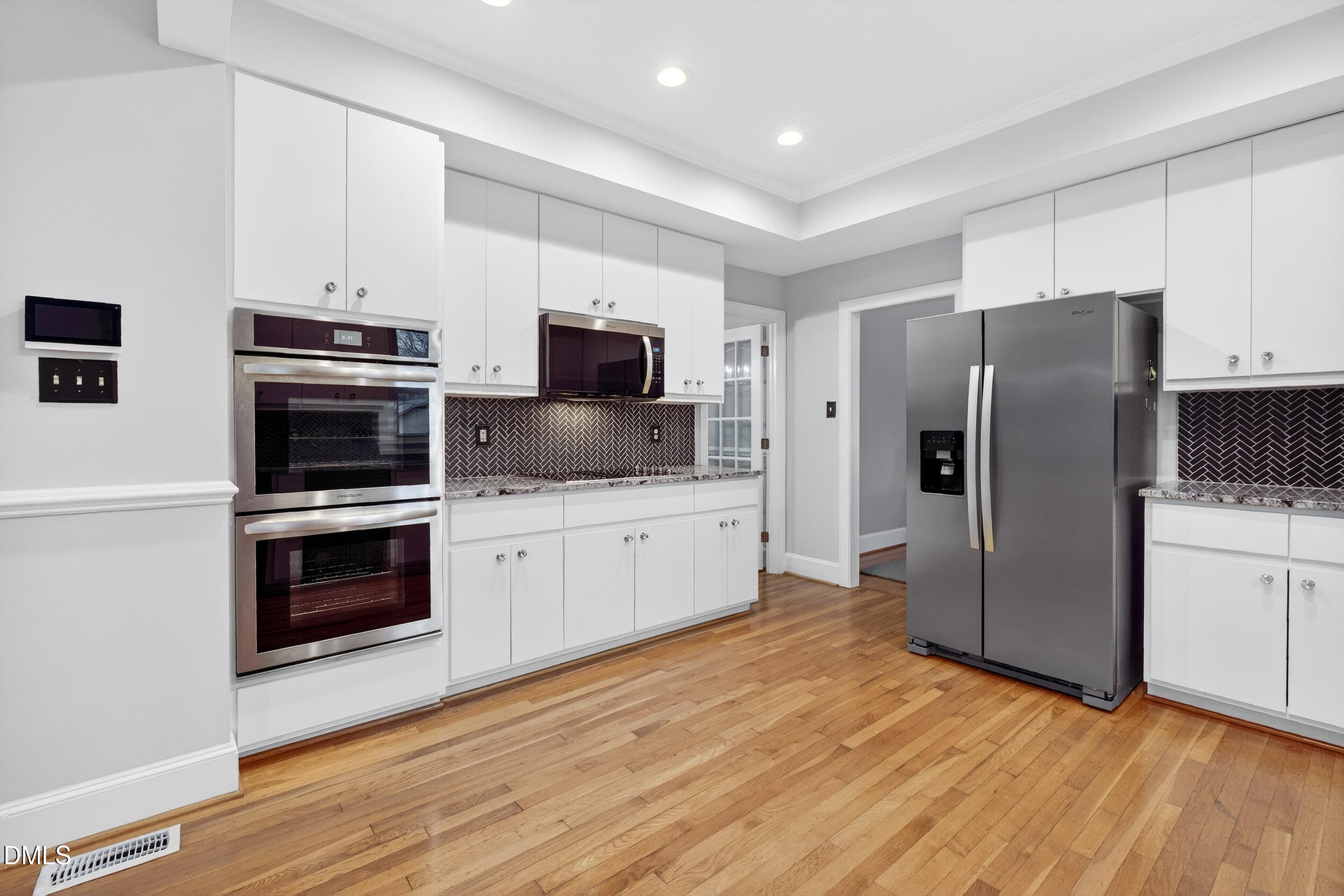 3735 Stoneybrook Drive Durham, NC 27705 - Photo 12 of 41 a kitchen with stainless steel appliances and wooden floor