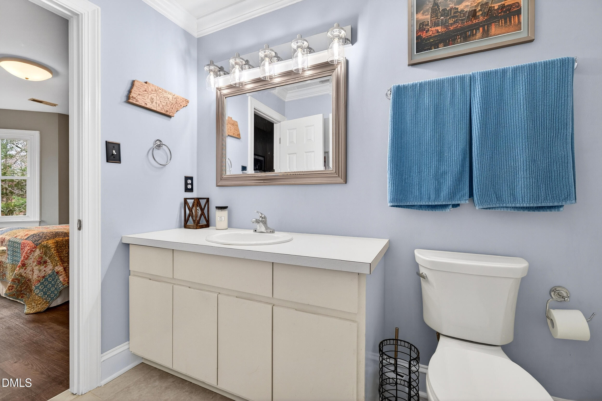 3735 Stoneybrook Drive Durham, NC 27705 - Photo 25 of 41 a bathroom with a toilet a sink and mirror