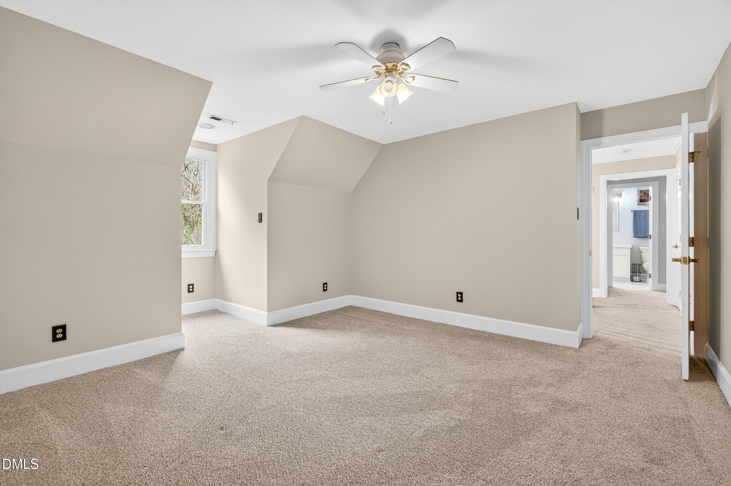3735 Stoneybrook Drive Durham, NC 27705 - Photo 27 of 41 an empty room with a chandelier fan and a bathroom