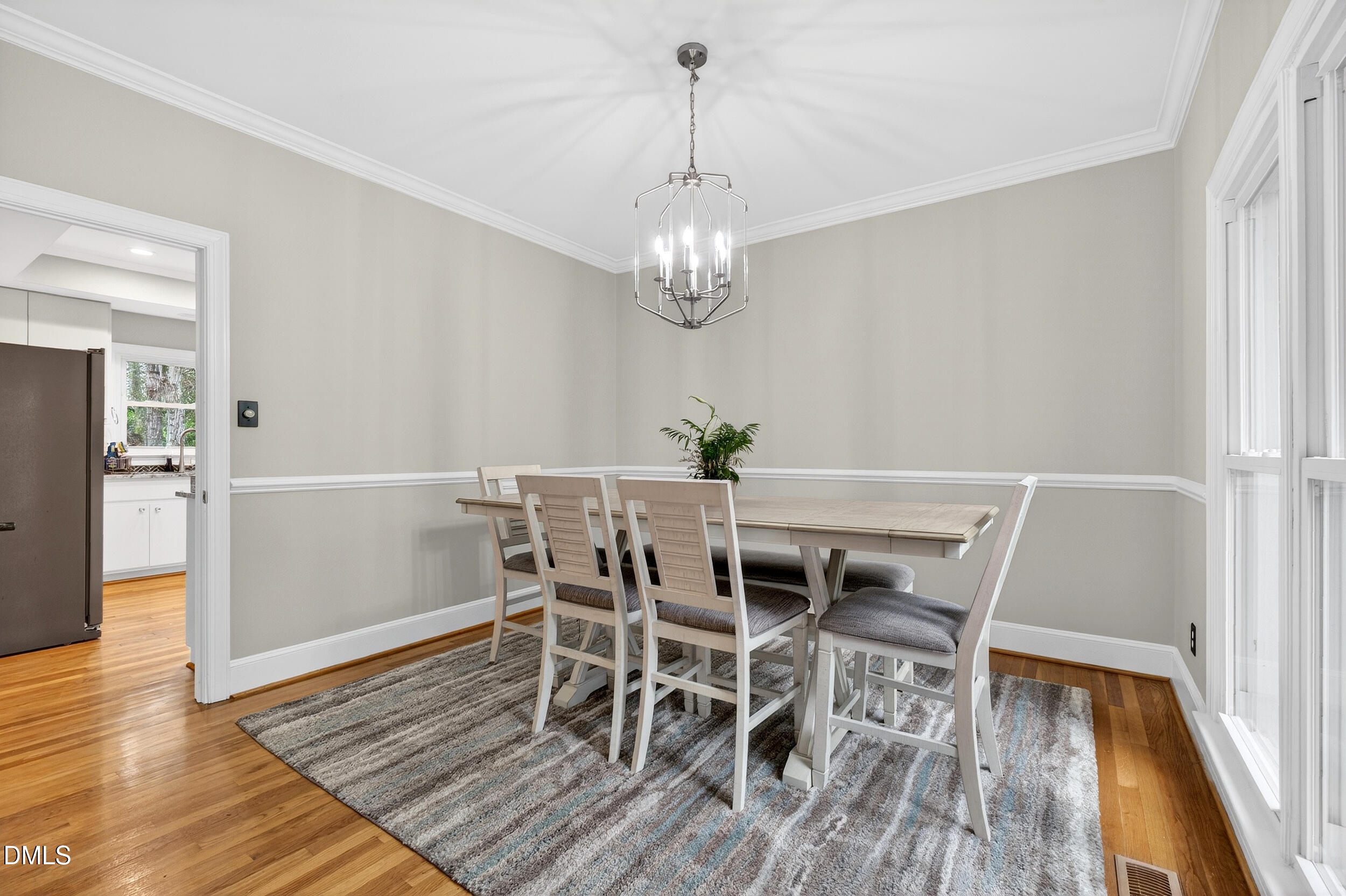 3735 Stoneybrook Drive Durham, NC 27705 - Photo 6 of 41 a view of a dining room with furniture wooden floor and chandelier