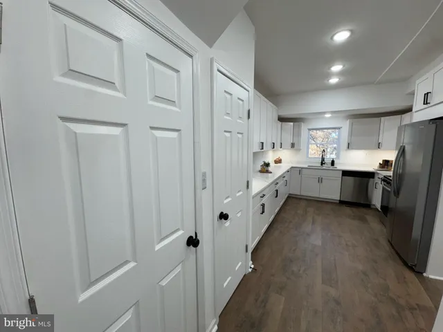 a kitchen with cabinets and stainless steel appliances