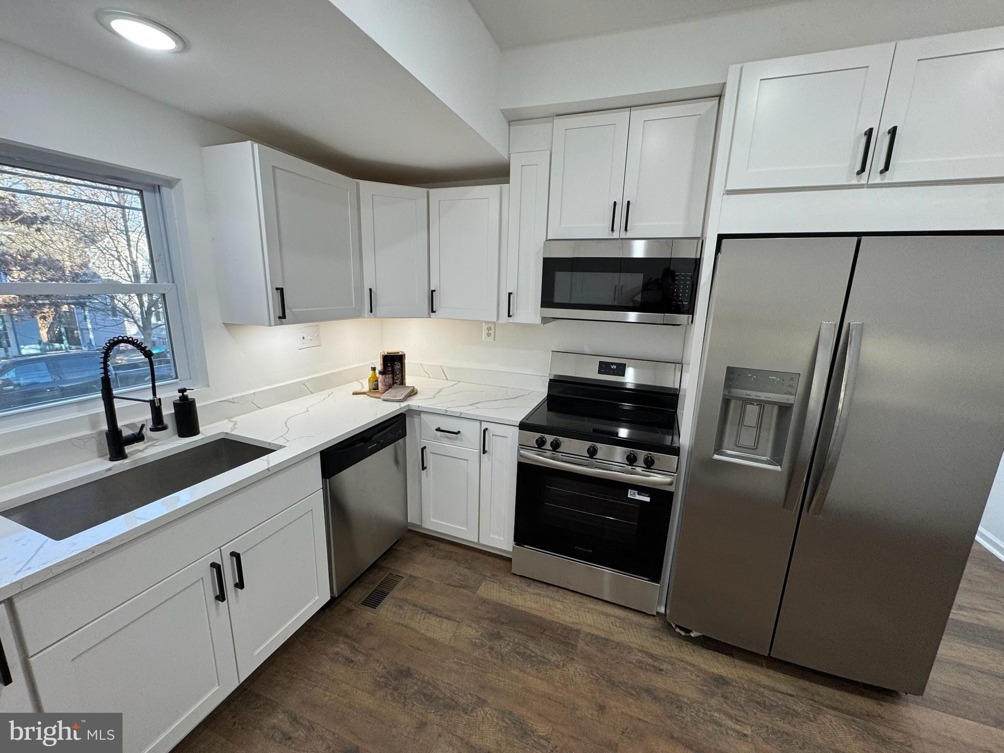 4116 32nd Street Mount Rainier, MD 20712 - Photo 15 of 51 a kitchen with cabinets stainless steel appliances and a sink