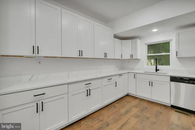 a kitchen with cabinets stainless steel appliances and a counter space