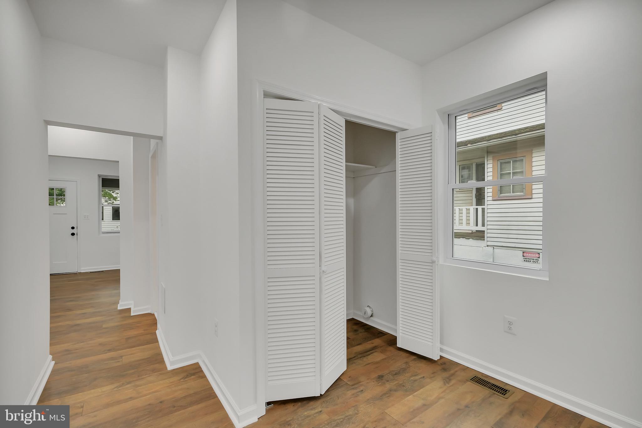 4116 32nd Street Mount Rainier, MD 20712 - Photo 21 of 51 a view of an empty room with wooden floor and a window