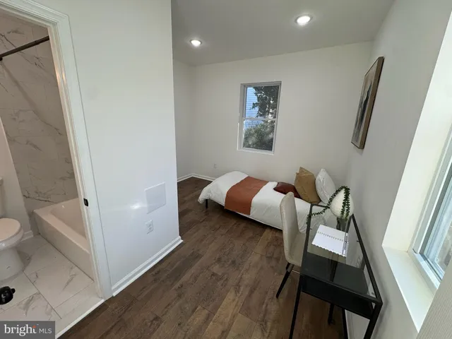 a bedroom with a bed and a view of bathroom