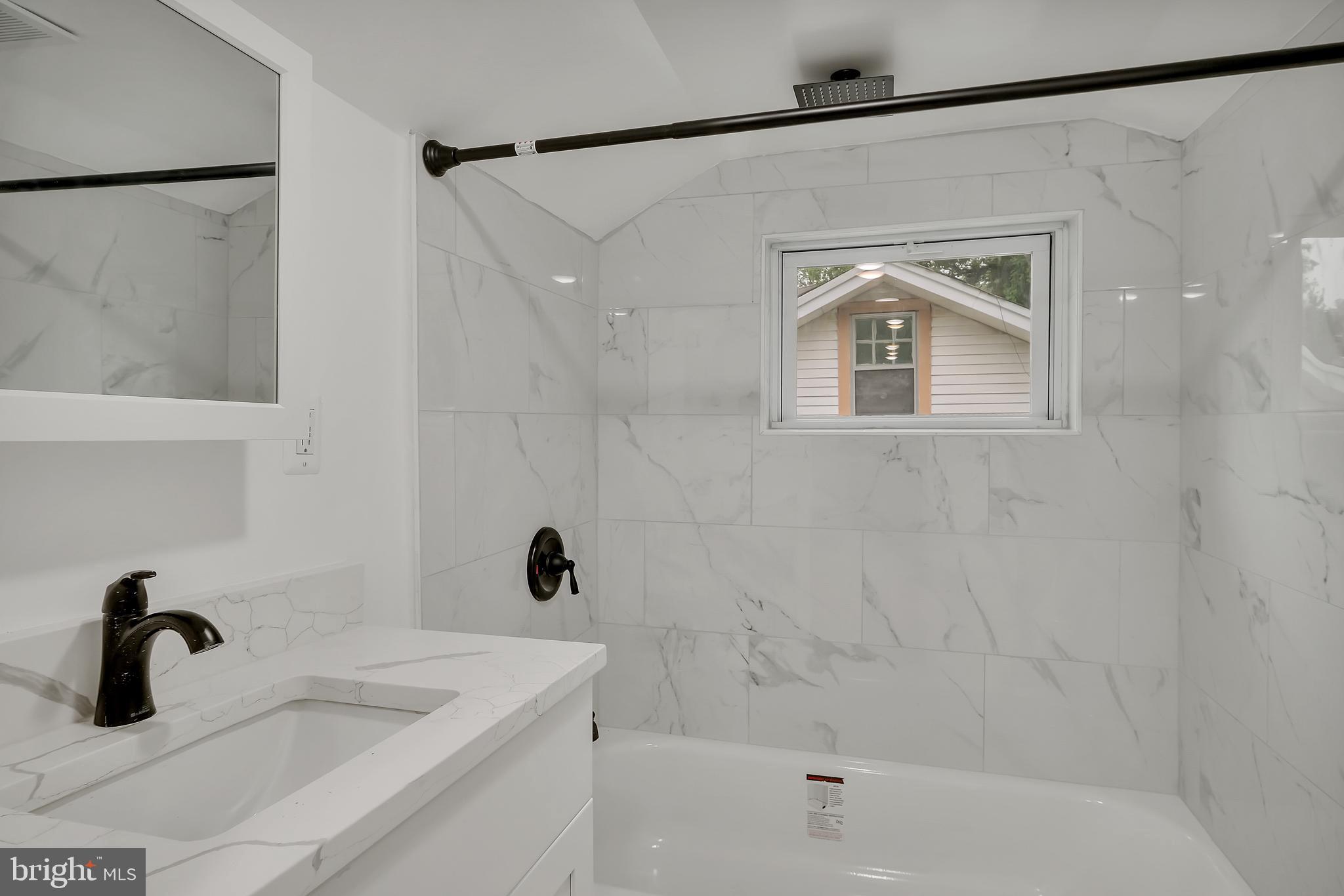 4116 32nd Street Mount Rainier, MD 20712 - Photo 35 of 51 a bathroom with a sink a glass door and shower