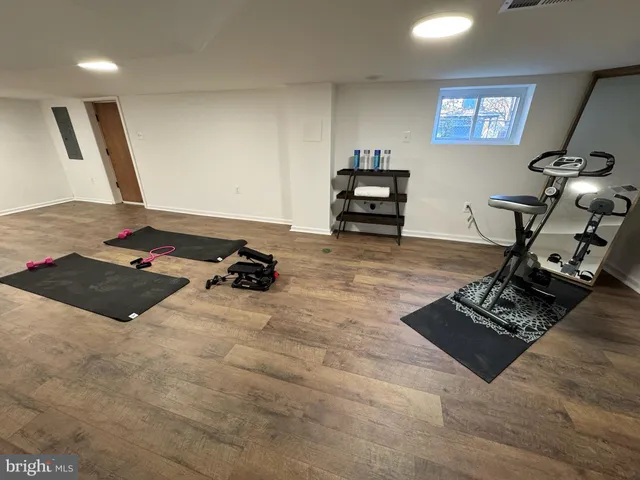 a living room with hard wood floors and a table