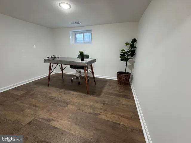a view of a room with a table and chairs