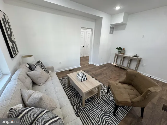 a bedroom with furniture and a wooden floor