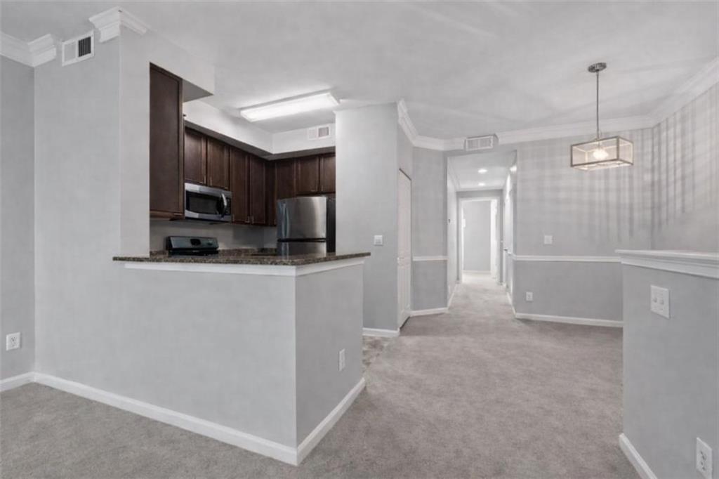 1752 Pryor Road Southwest, Unit 111 Atlanta, GA 30315 - Photo 5 of 20 a view of a kitchen with a sink and a refrigerator