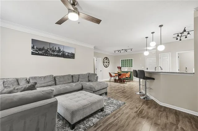 a living room with furniture and a chandelier