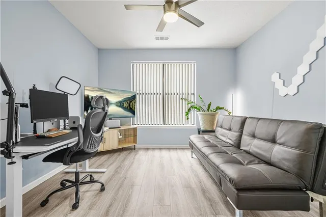 a living room with furniture and a wooden floor