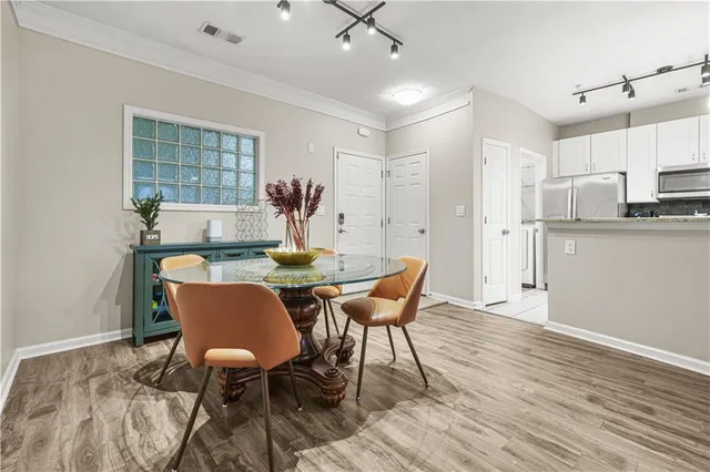 a view of a dining room with furniture and wooden floor