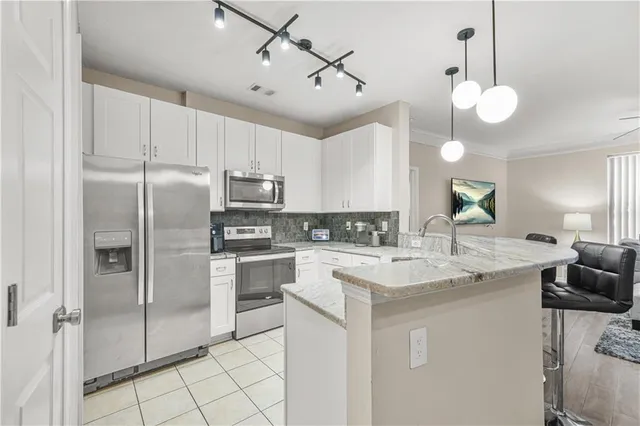 a kitchen with cabinets stainless steel appliances and a counter top space