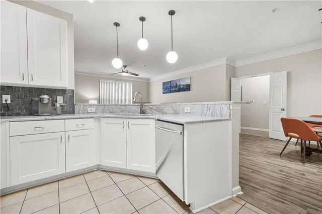 a view of a kitchen with kitchen island and stainless steel appliances