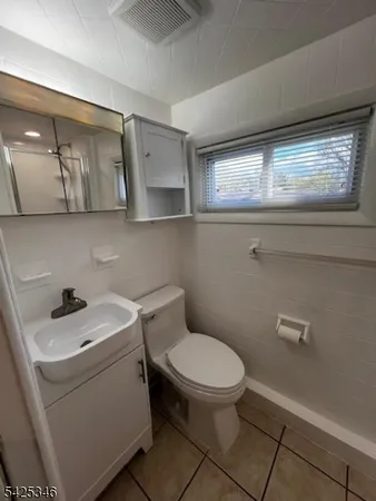 a white toilet sitting next to a bathroom sink