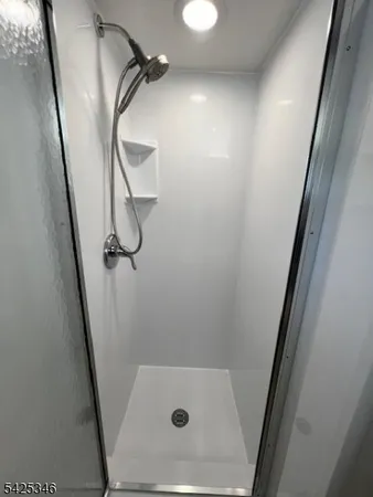 a bathroom with a glass door shower