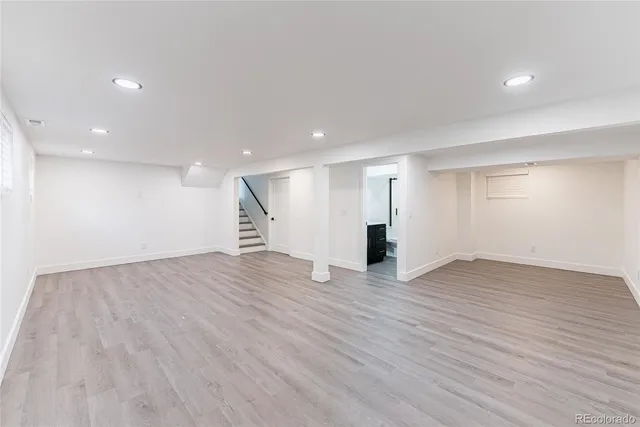 a view of empty room with wooden floor